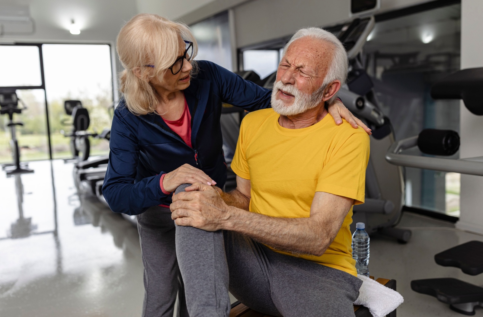 A fellow resident comforts a senior who has injured themselves while performing too strenuous of an exercise